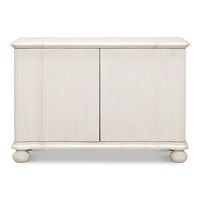 Front view of reeded antique white cabinet, closed doors.