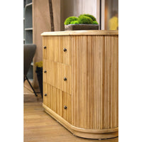 Contextual shot of dresser, wooden floor, with decor.