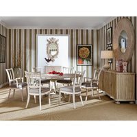 Dining room setting featuring white washed buffet cabinet.