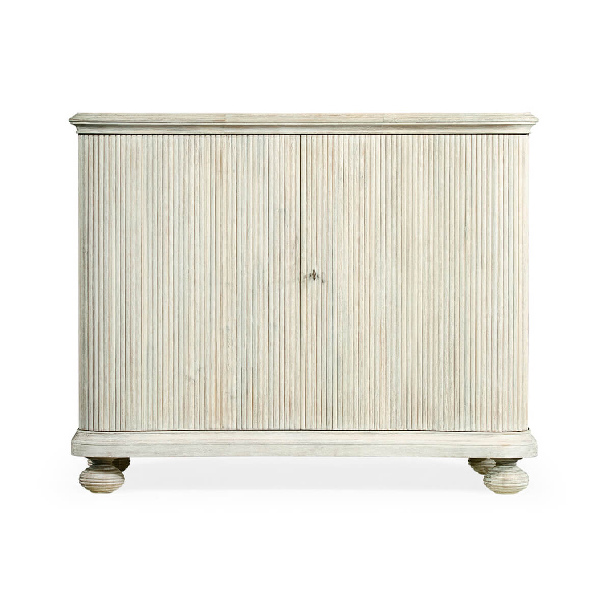 Front view of reeded cabinet, closed doors, white wash.