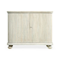 Front view of reeded cabinet, closed doors, white wash.