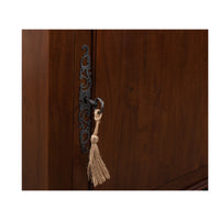 Close-up of cabinet handle with tassel key.