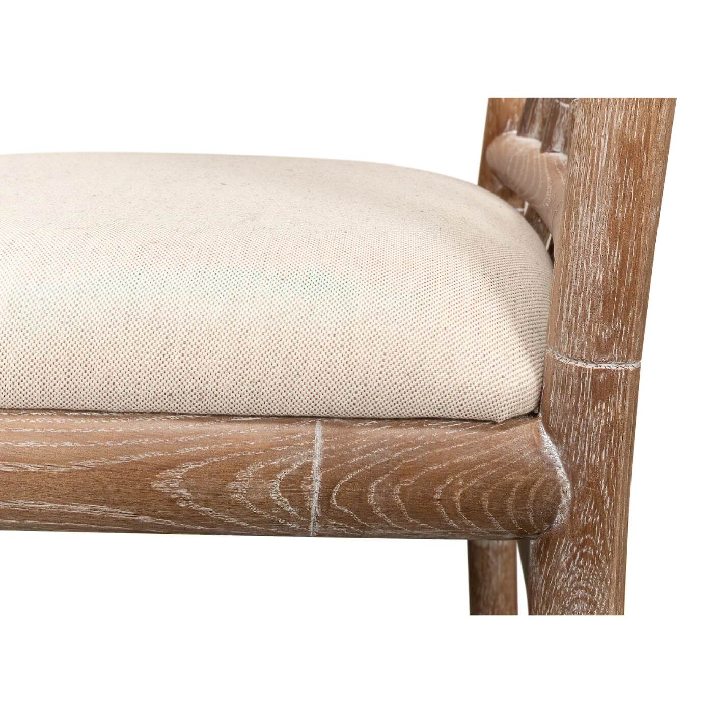 Close-up of chair cushion, beige fabric, wooden frame.