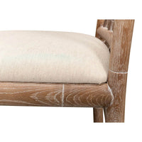 Close-up of chair cushion, beige fabric, wooden frame.