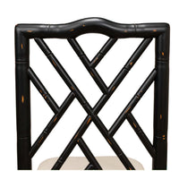 Close-up of chair's black faux bamboo backrest.