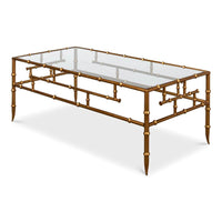 Angled view of gilt bamboo coffee table, glass top.