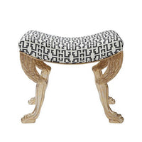 Stool with gold lion paw legs, black geometric seat.