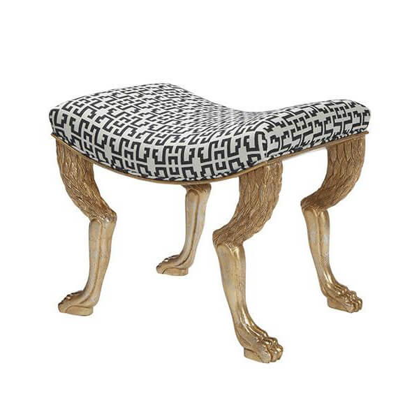 Side angle of gold leg stool with patterned cushion.