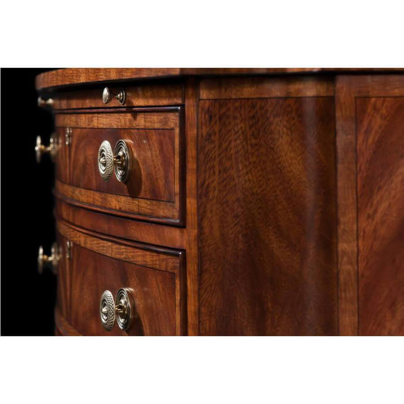 Close-up of drawer handles on Regency mahogany chest.