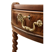 Close-up of ornate handle on round side table.