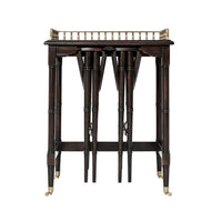 Side tables stacked with focus on ornate railing.