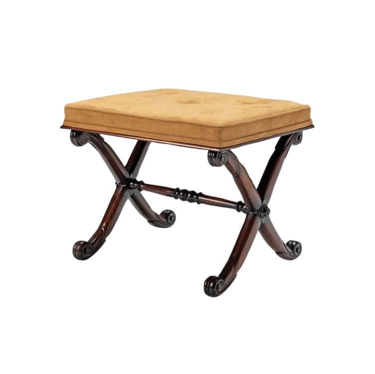 Regency stool with carved mahogany X frame, side view.