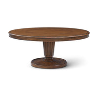 Round dining table with pedestal base, side view.
