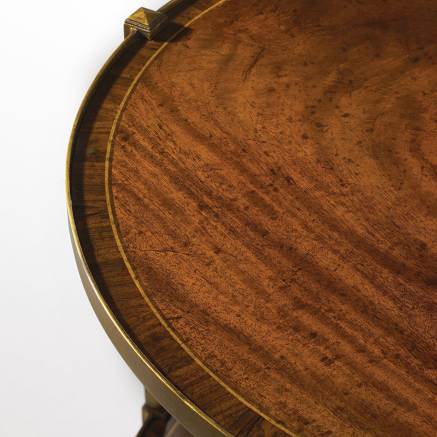 Close-up of wooden surface on brass end table.