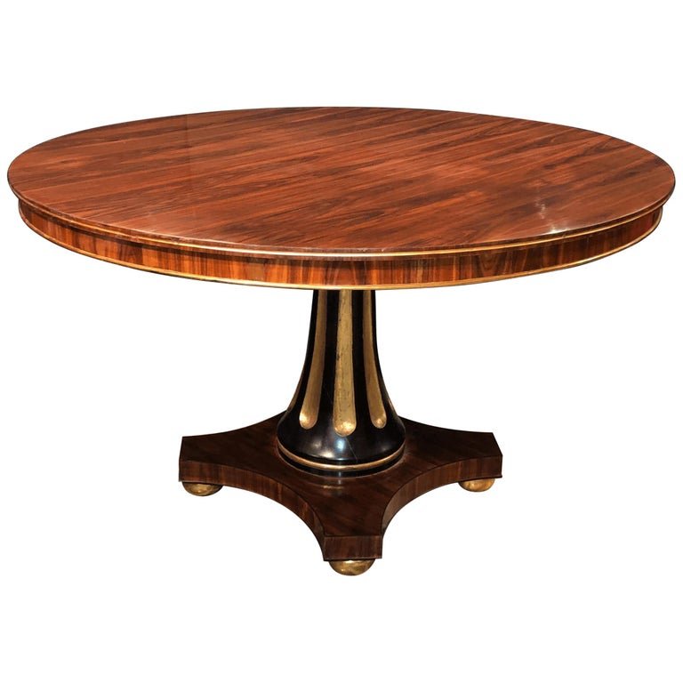 Round wooden center table with pedestal base.