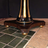 Close-up of ornate pedestal base design on center table.