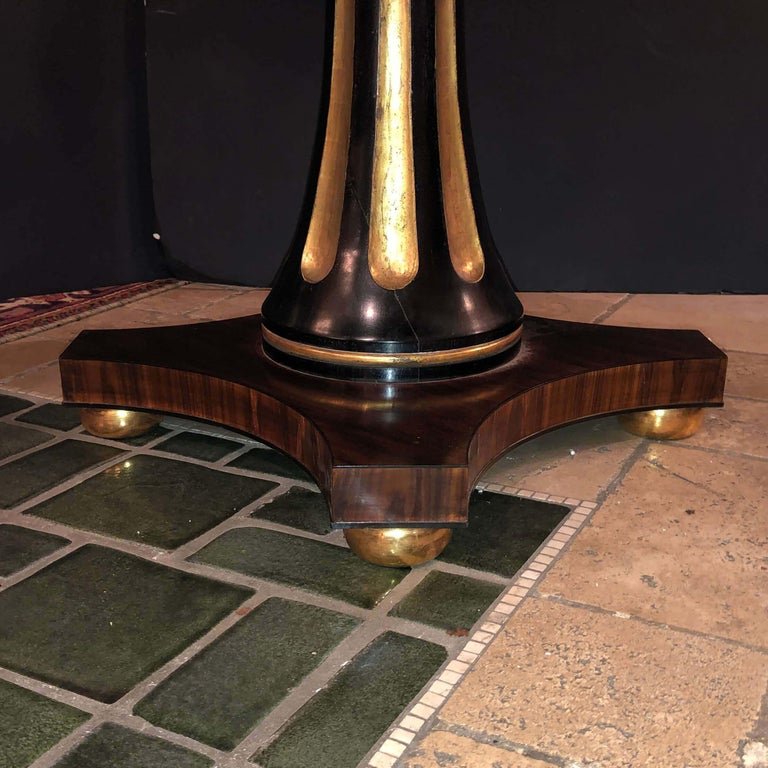 Close-up of ornate pedestal base design on center table.