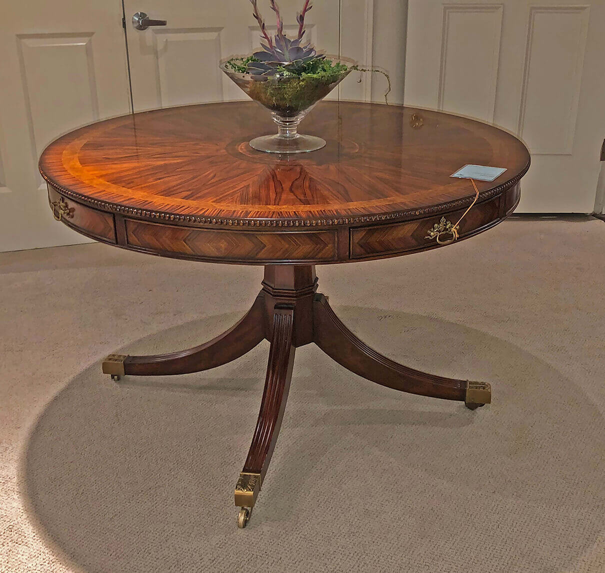 Regency style center table in room setting, decorative piece.