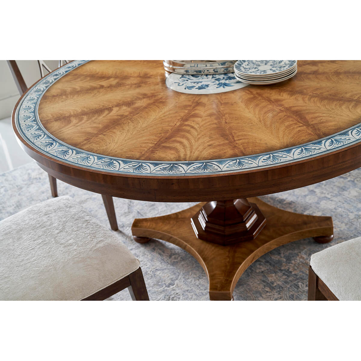 Regency dining table with chairs and decorative plates.