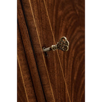 Key inserted in mahogany sideboard lock.