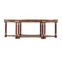 Side view of ornate oval coffee table with columns.