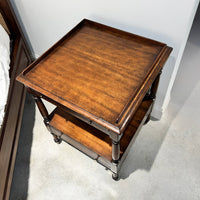 Top view of Regency style side table in bedroom setting.