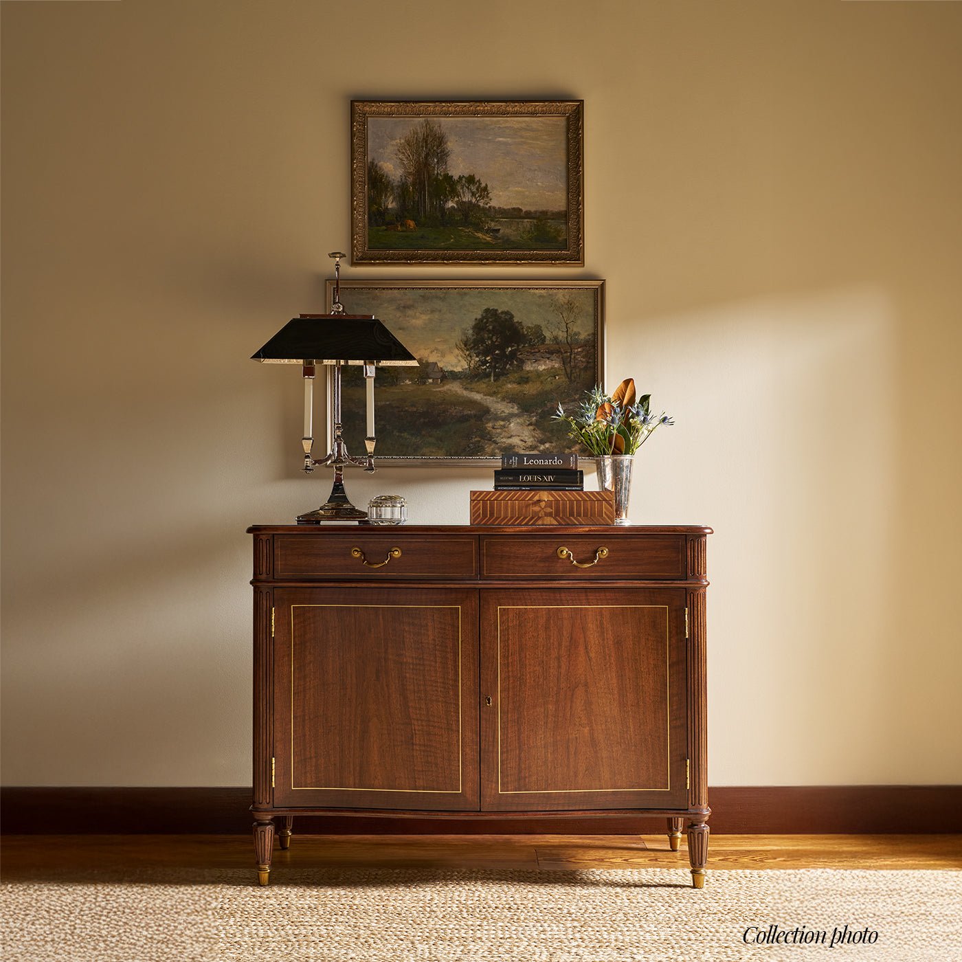 Regency style sideboard buffet against wall with artworks.