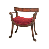 Regency style armchair with red cushion, wooden floor.