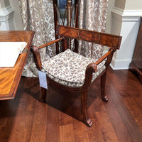 Regency style armchair, leopard print cushion, wooden floor.