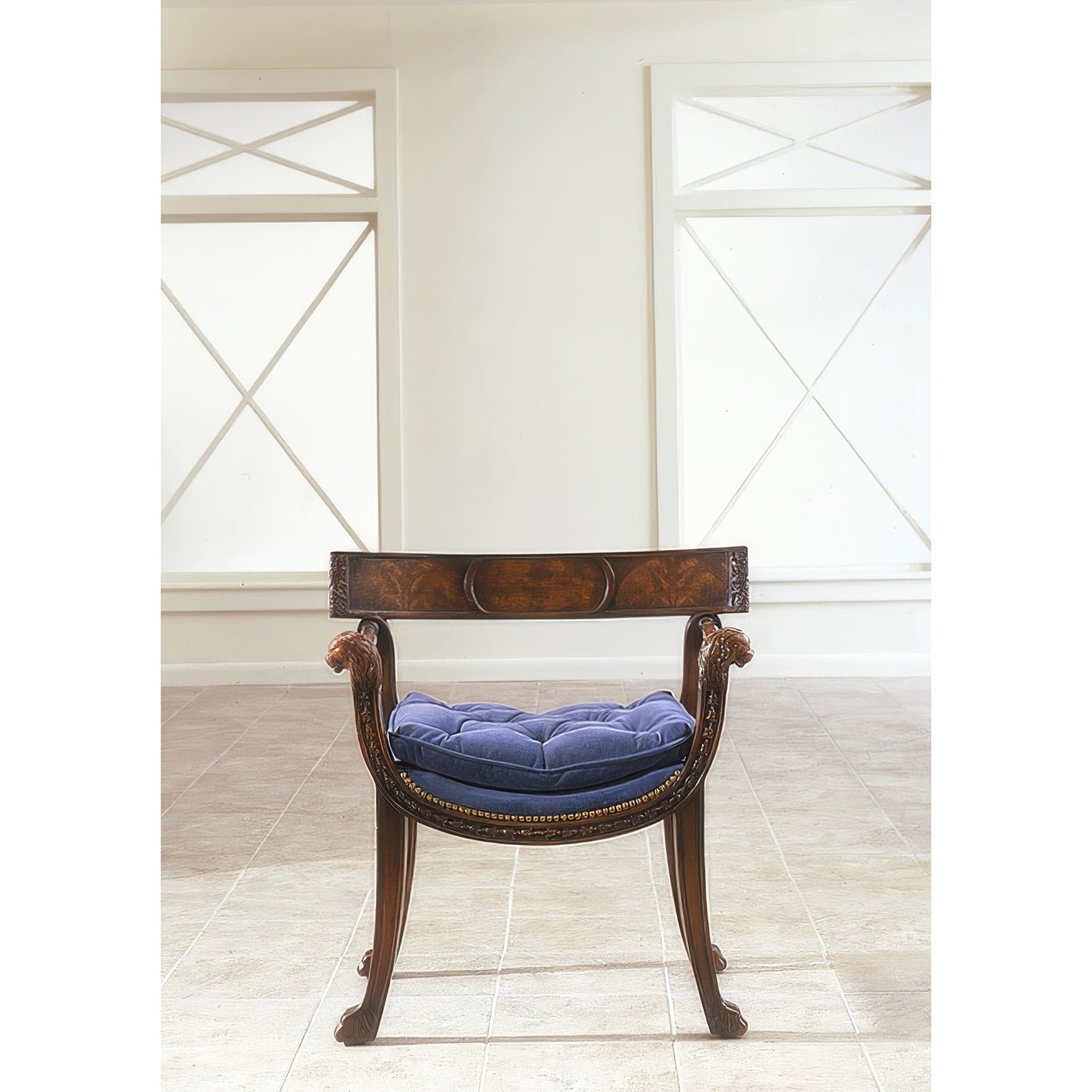 Regency style armchair with blue cushion, bright windows.