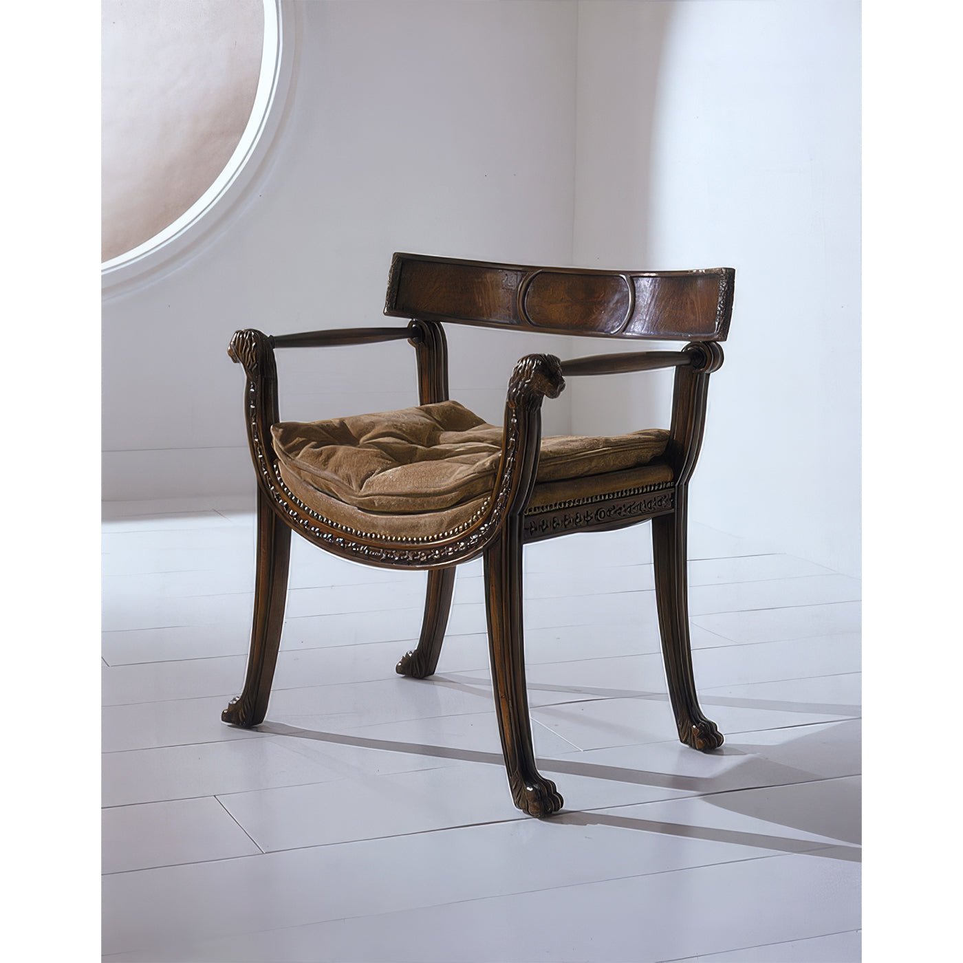 Regency style armchair with beige cushion, white floor.