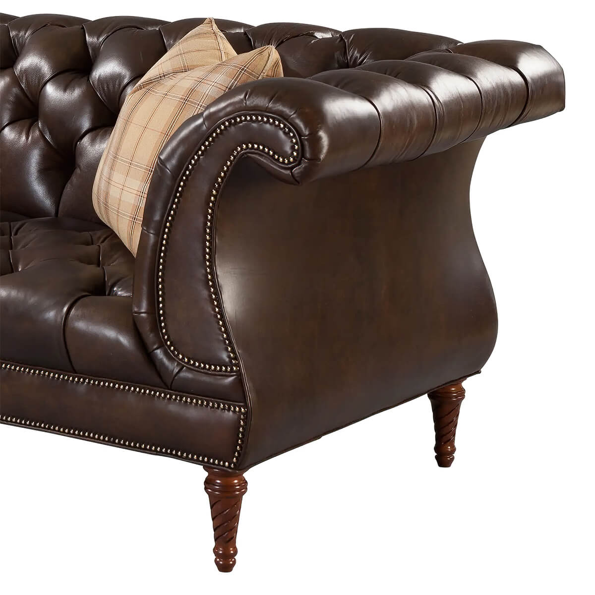 Close-up of dark brown leather sofa arm details.