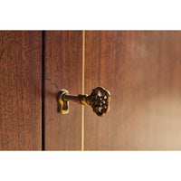 Close-up of cabinet lock and decorative key in place.