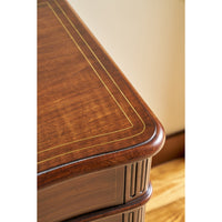 Cabinet corner detail, wood grain, decorative inlay.