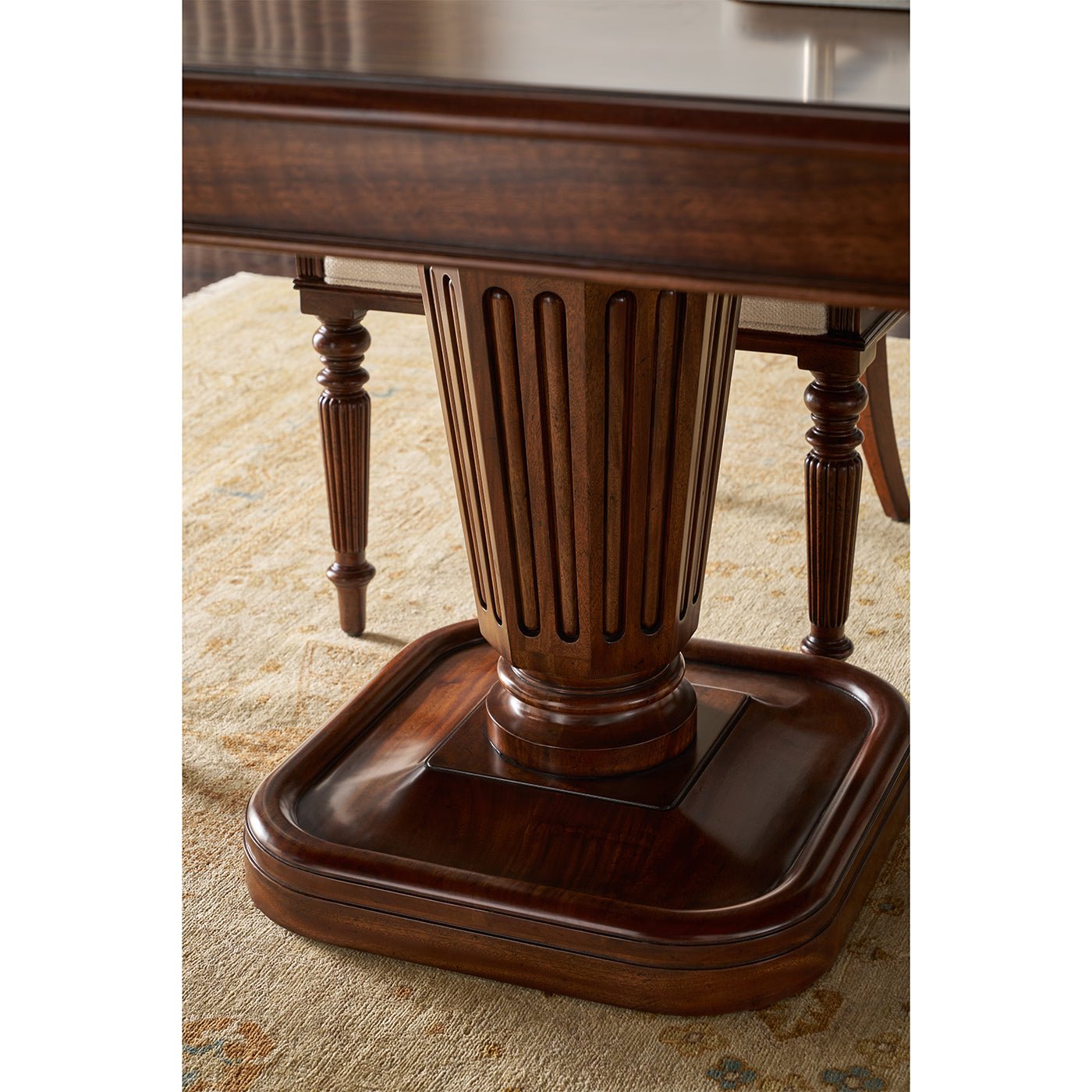 Close-up of walnut pedestal base, intricate details, wood finish.