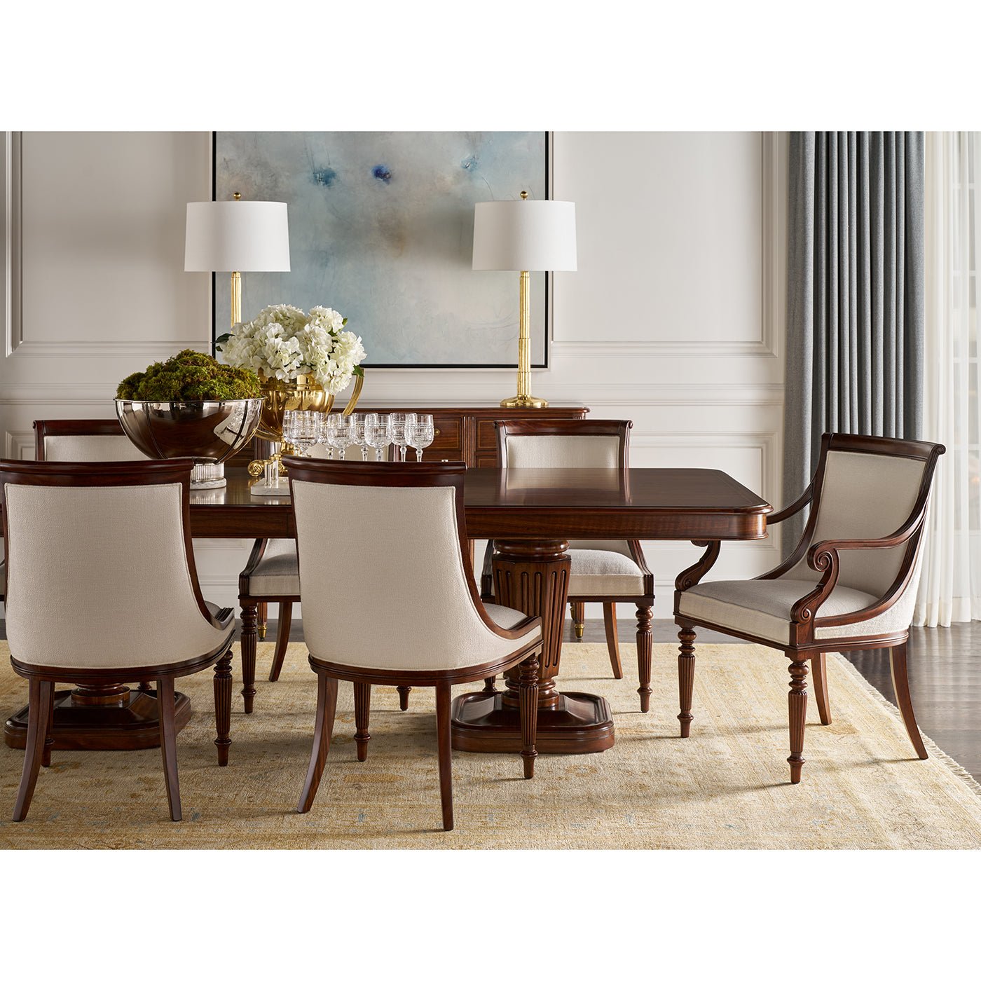 Dining room setting with walnut table and chairs, elegant decor.