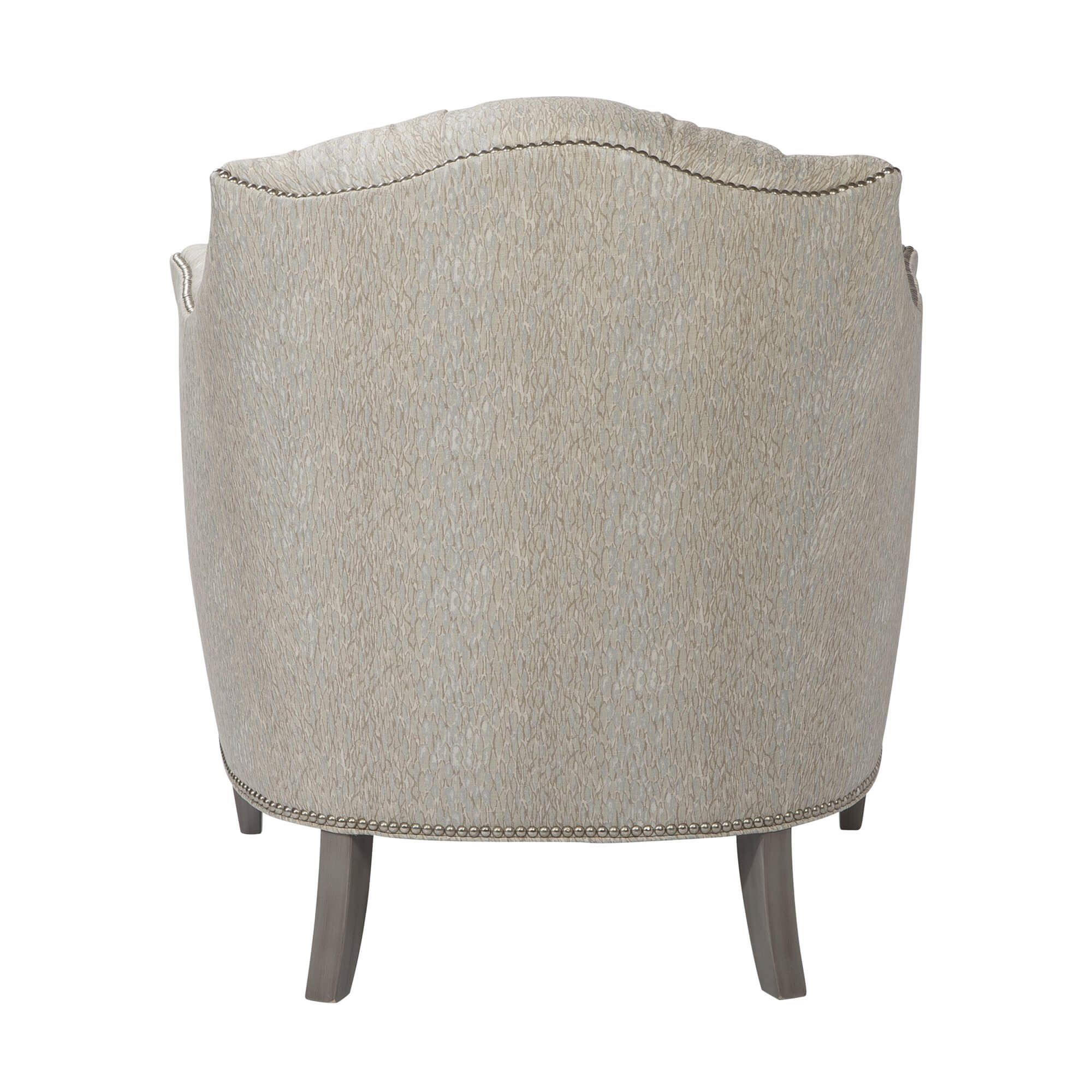 Light upholstered tufted chair, back view with elegant curves.