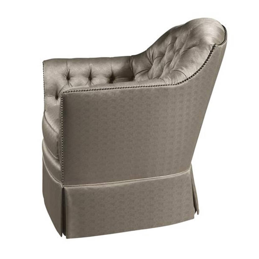 Upholstered tufted chair, side view showing armrest details.