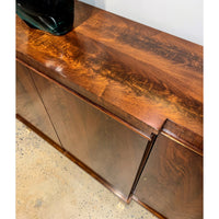 Close-up of Regency walnut credenza's polished wood surface.