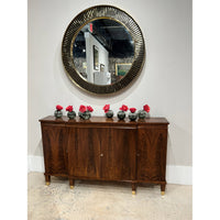 Regency walnut credenza with decorative flowers and round mirror.