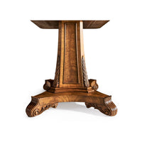 Close-up of ornate pedestal base on center table.