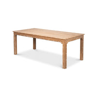 Side angle of oak dining table with design details.