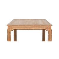 Close-up front of oak dining table edge.