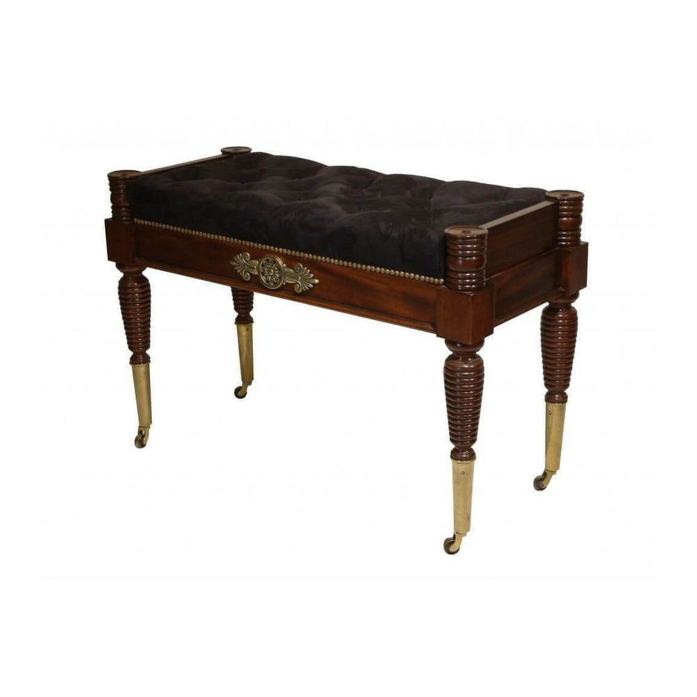 Antique-style Regency window bench with wooden legs and upholstery.
