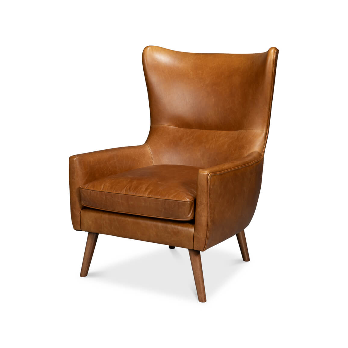 Brown leather wingback chair, front-left view, wood legs.
