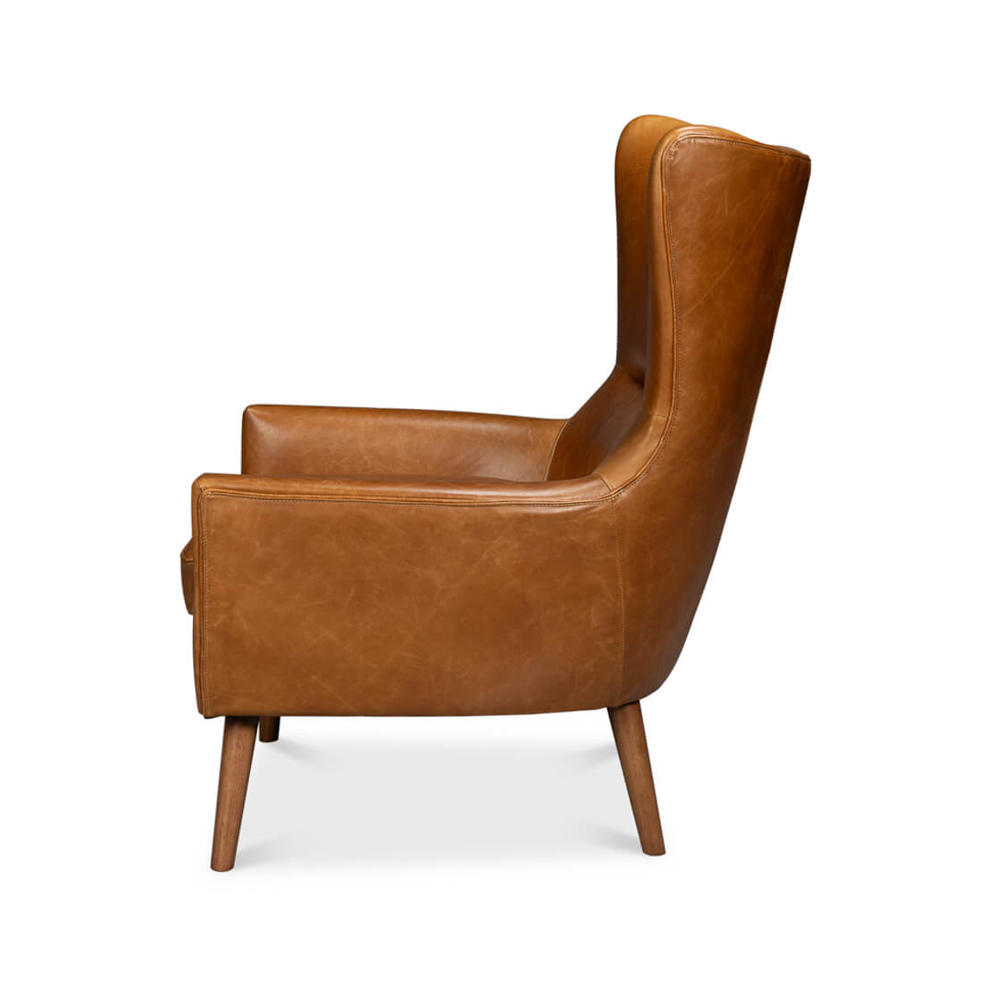 Side view of brown leather wingback chair, arms visible.