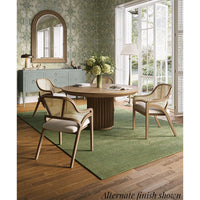 Dining table in room setting with chairs and decor.