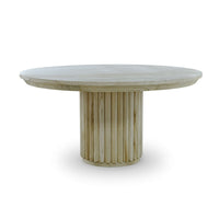 Round dining table in fruitwood finish, side view.