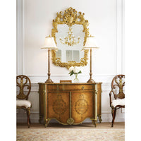 Rococo giltwood mirror above console with decor.