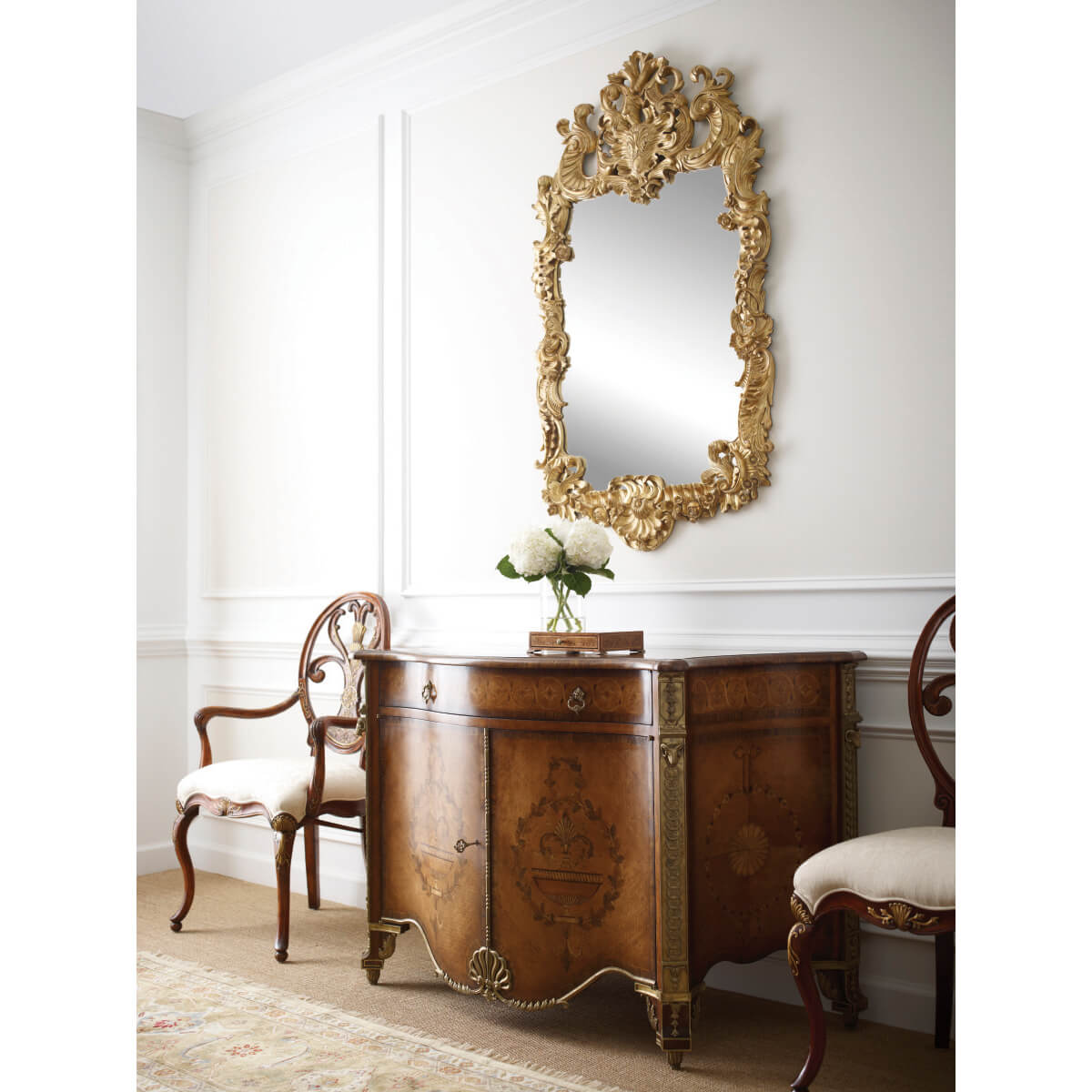 Rococo giltwood mirror in elegant living room setting.